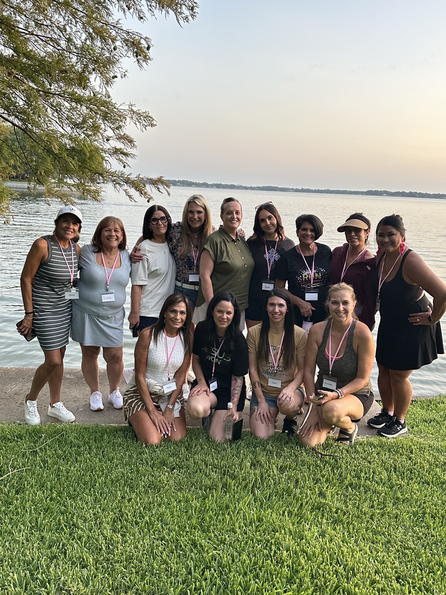 SHE Ventures women posing together on the lakeshore at golden hour