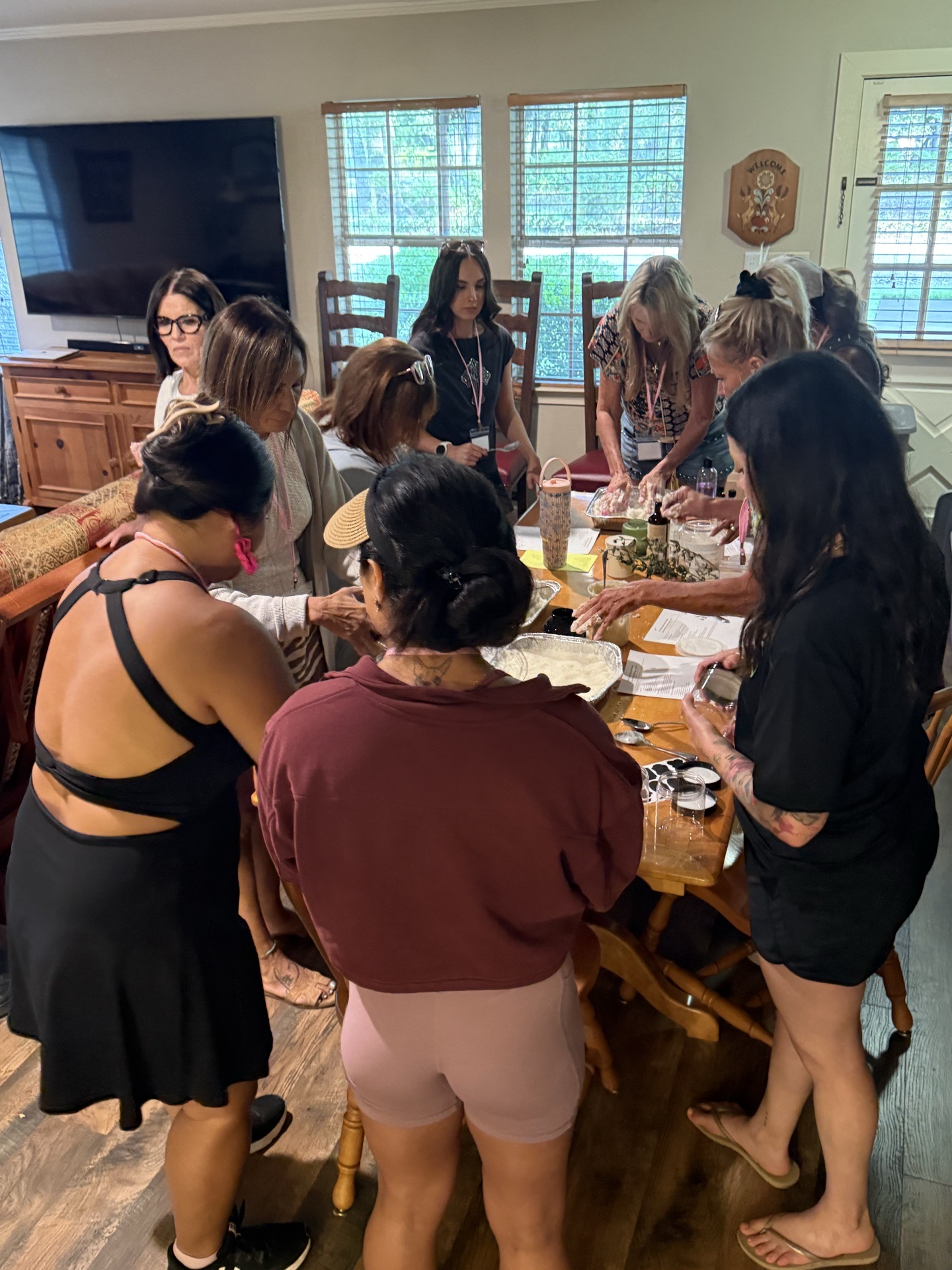Women gathered around a farmhouse table for a hands-on craft night